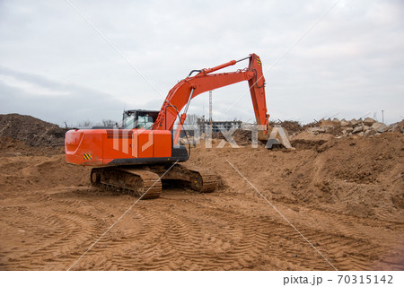 Track-type excavator during earthmoving at construction site.  70315142