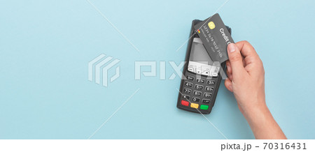 Man using credit card and payment terminal 70316431