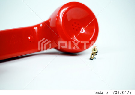 red earphone on call with the office boy 70320425
