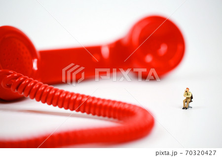 red earphone on call with the office boy 70320427
