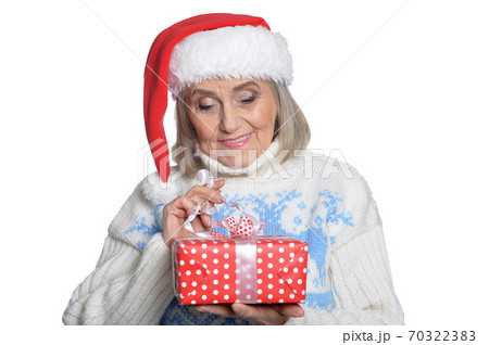 Portrait of smiling senior woman in Santa hat posing 70322383
