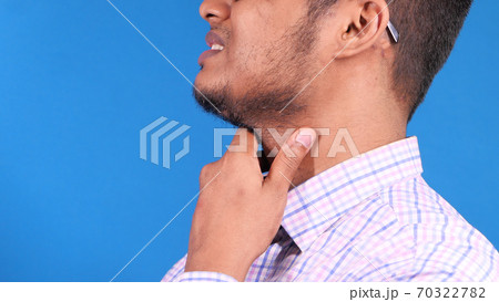 young man suffering pain in his throat young man suffering pain in his throat 70322782