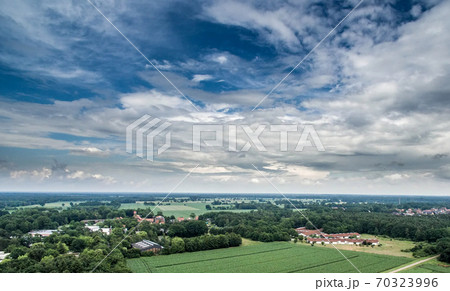 Aerial view of an area of arable land at the edge of a village 70323996