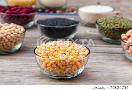 Corn in blow on a wood table background. corn seeds in blow Corn in blow on a wood table background. corn seeds in blow 70324752