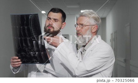 Two male doctors discussing MRI scan of their patient 70325066