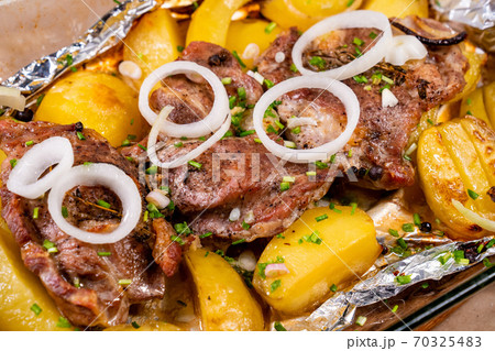 baked in foil pork neck and potatoes and onion baked in foil pork neck and potatoes and onion 70325483