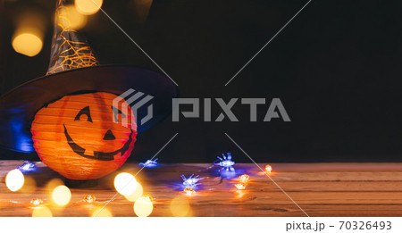 Original decorations with pumpkins and halloween witch hats on rustic wooden background. Original decorations with pumpkins and halloween witch hats on rustic wooden background. 70326493