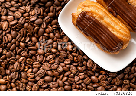 fragment cakes with chocolate icing on coffee 70326820