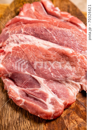 a raw meat, pig neck on a wooden background 70326821