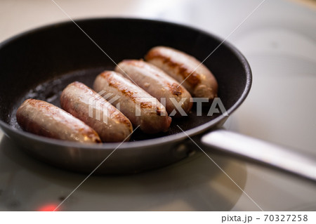 five sausages fried in pan. semi-finished products five sausages fried in pan. semi-finished products 70327258