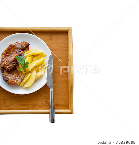 home cooking. meat and potatoes on a white plate.  70329689