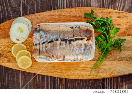 top view sliced salted herring plate onion lemon  70331392
