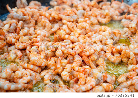 seafood street food. king prawns fried in  pan.  70335541