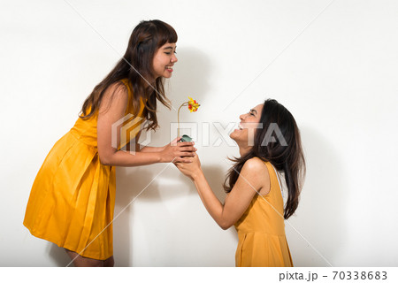 Portrait of two happy young Asian women together 70338683