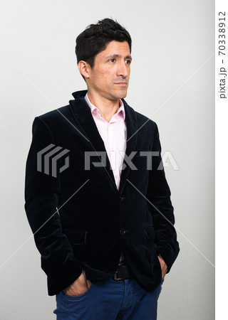 Portrait of Hispanic businessman in suit thinking Portrait of Hispanic businessman in suit thinking 70338912