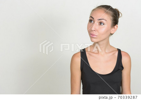 Portrait of young woman with brown hair thinking Portrait of young woman with brown hair thinking 70339287