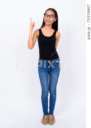 Full body shot of young Asian nerd woman pointing up Full body shot of young Asian nerd woman pointing up 70339867