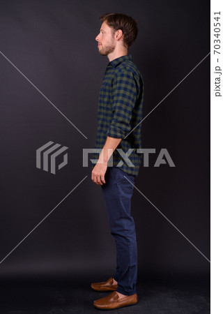 Full body shot profile view of bearded hipster man 70340541