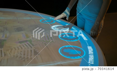 Woman using interactive display with no touch control technology Woman using interactive display with no touch control technology 70341614