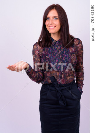 Portrait of happy young beautiful businesswoman showing something 70343190
