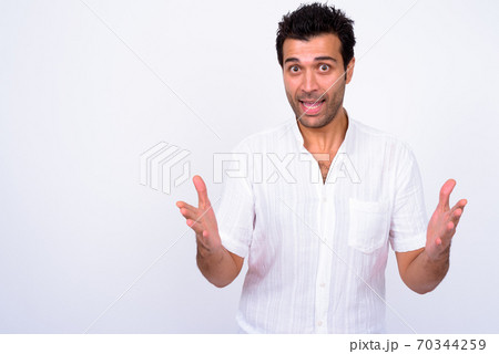 Portrait of happy handsome Turkish man explaining something Portrait of happy handsome Turkish man explaining something 70344259