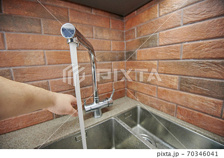 Water running from metal faucet Water running from metal faucet 70346041