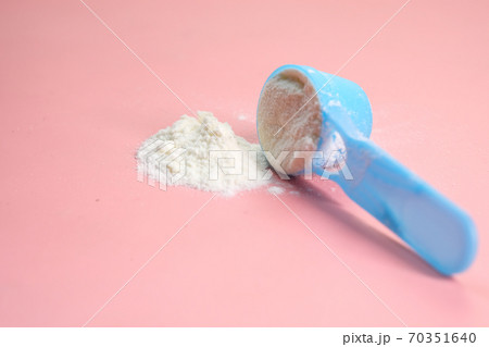 Close up of baby milk powder and spoon on pink background. Close up of baby milk powder and spoon on pink background. 70351640