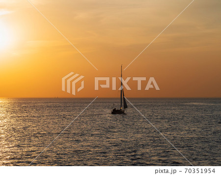 Yacht in calm at sunset. Minimalistic seascape. Yacht in calm at sunset. Minimalistic seascape. 70351954