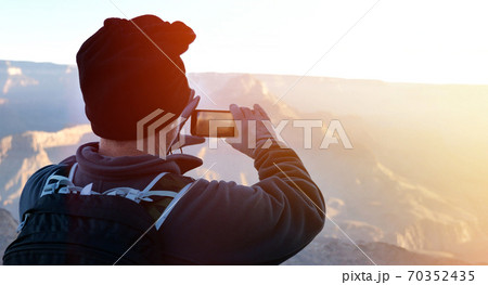 Hiker with smartphone taking panormic nature shots Hiker with smartphone taking panormic nature shots 70352435