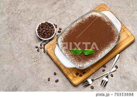 Traditional Italian Tiramisu dessert in glass baking dish on concrete background 70353698