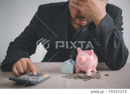 Businessman is stressed out of losing their jobs and insufficient savings to pay for a mortgage. 70355274
