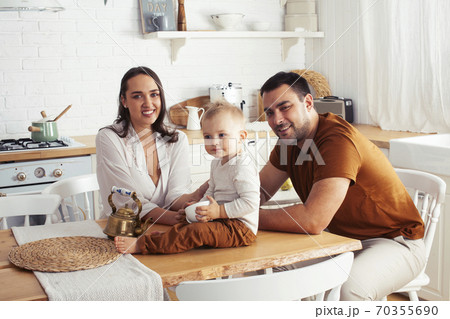 young family with little cute son on kitchen in morning happy smiling, lifestyle people concept 70355690