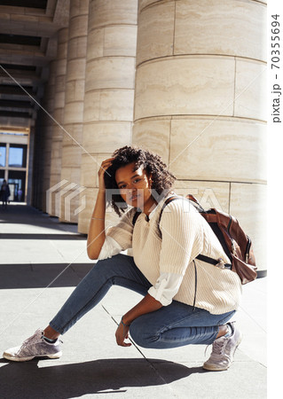 young pretty african girl posing cheerful on city background, lifestyle outdoor people concept young pretty african girl posing cheerful on city background, lifestyle outdoor people concept 70355694
