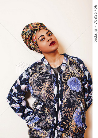 beauty bright african woman with creative make up, shawl on head like cubian closeup smiling 70355706