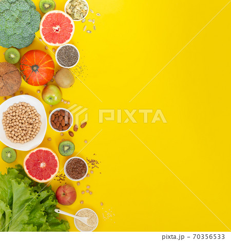 Superfoods on yellow background with copy space. Vegetables, fruits, herbs and seeds 70356533