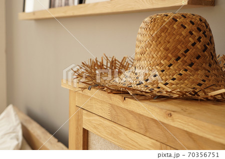 Straw hat on the shelf in room in a Scandinavian style 70356751