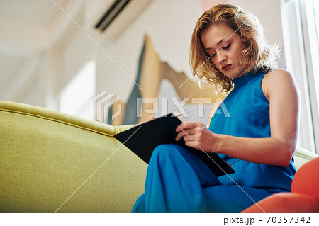 Woman correcting document Woman correcting document 70357342