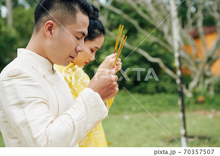 Asian couple praying Asian couple praying 70357507