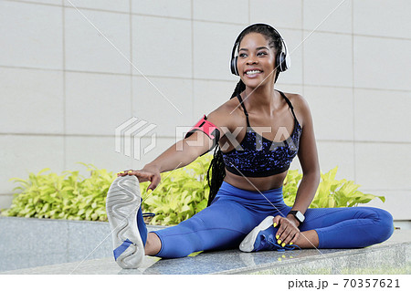 Fit woman stretching leg 70357621