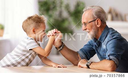Grandfather arm wrestling with grandson. Grandfather arm wrestling with grandson. 70357866