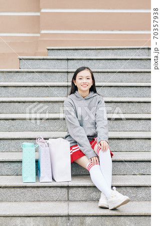 Teenage girl sitting on steps 70357938