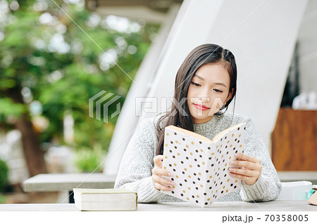 Teenage girl enjoying reading Teenage girl enjoying reading 70358005