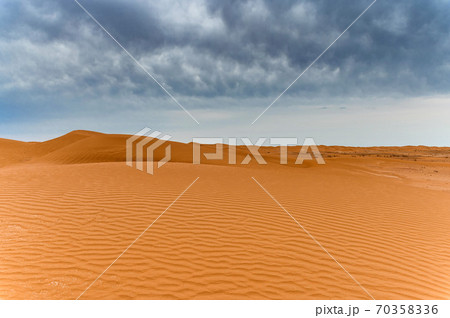 Picturesque desert landscape with dunes and dramatic sky 70358336