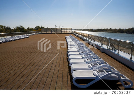 Cruise ship sun deck with line of lounge chairs 70358337