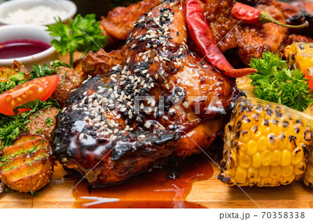 Barbecue chicken with vegetables on wooden table 70358338