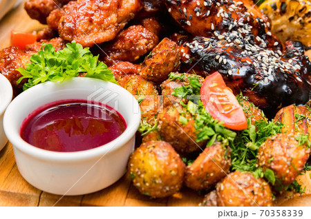 Barbecue chicken with vegetables on wooden table Barbecue chicken with vegetables on wooden table 70358339
