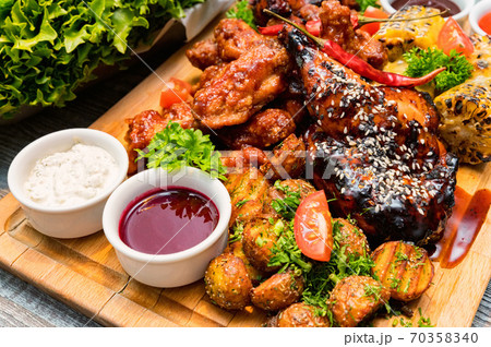 Barbecue chicken with vegetables on wooden table 70358340