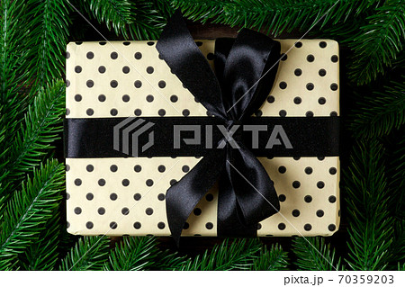Top view of festive gift box decorated with green fir tree branches. Christmas time with copy space 70359203
