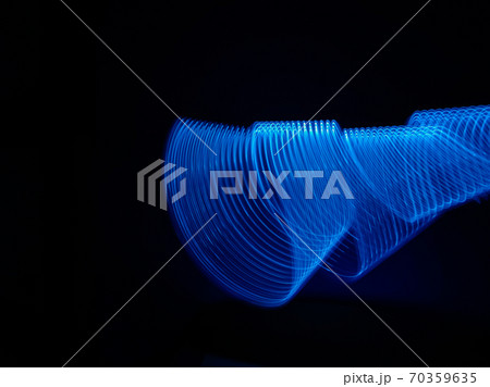 Beautiful graphic shapes made of light with a long exposure. Background pattern in shades of classic blue color of the year 2020. 70359635