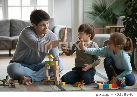 Happy dad and little kids give high five playing 70359946